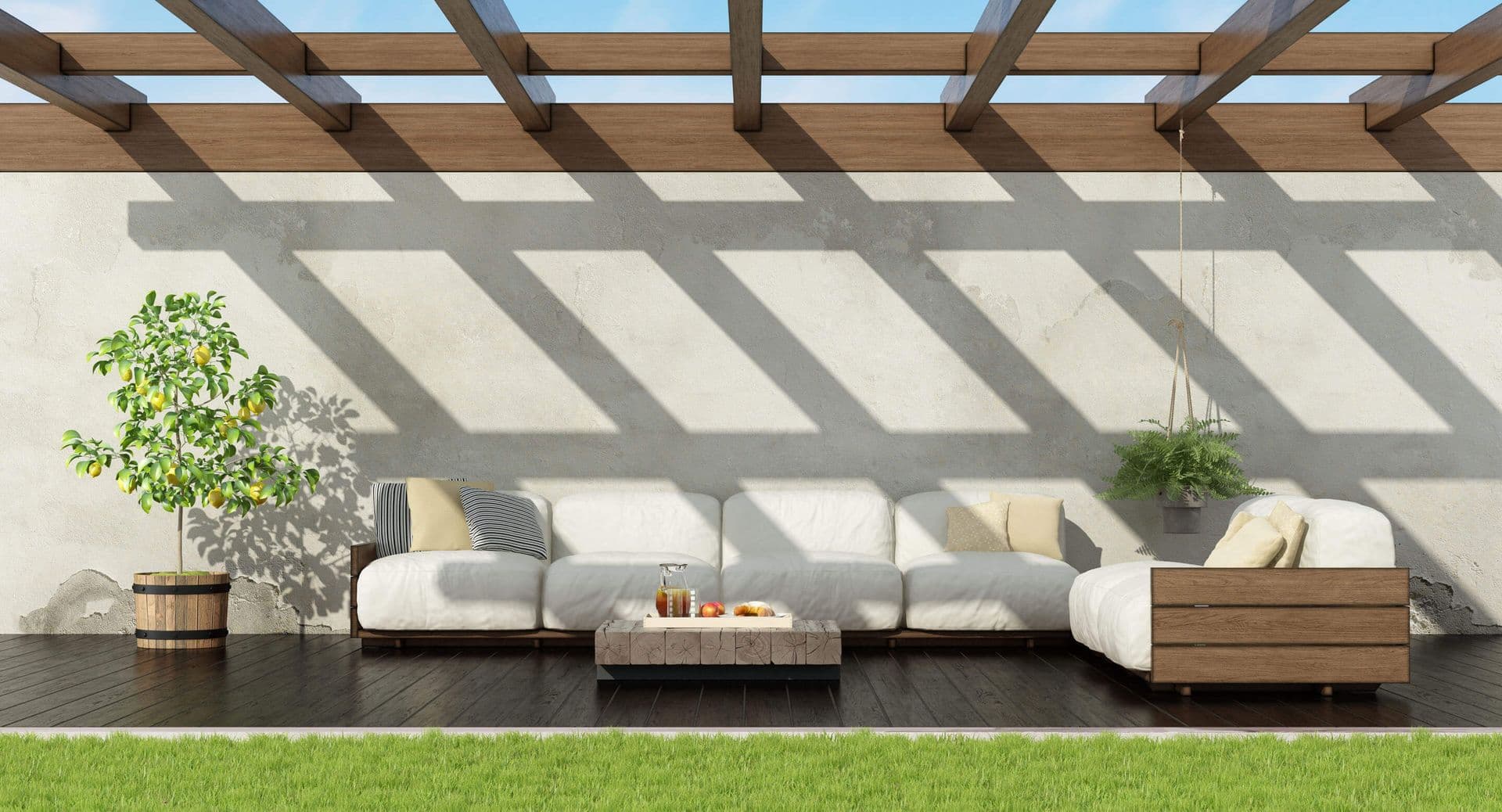 A dark brown deck with a lighter brown pergola and a white patio couch.