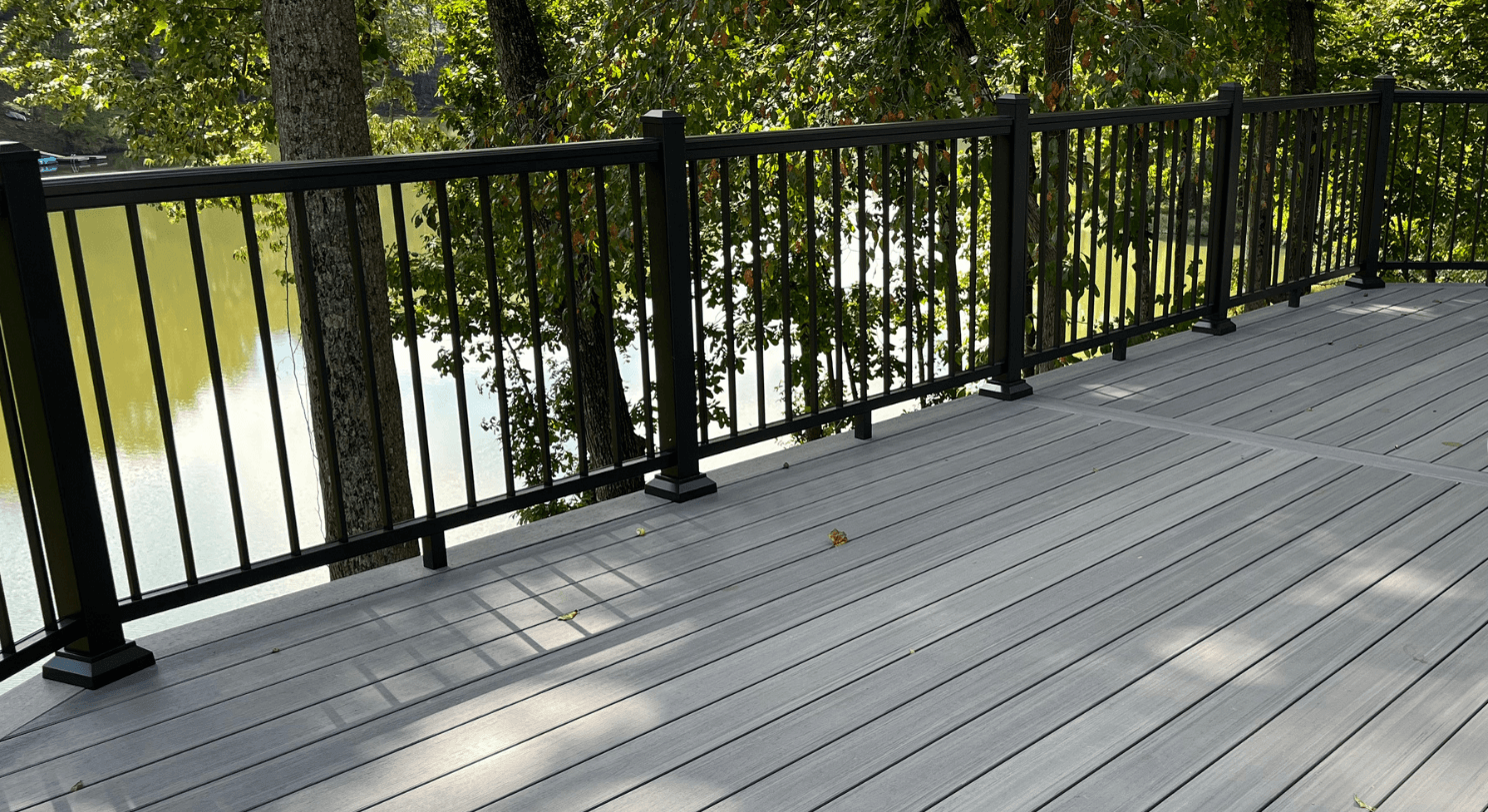 A gray deck with black railings.