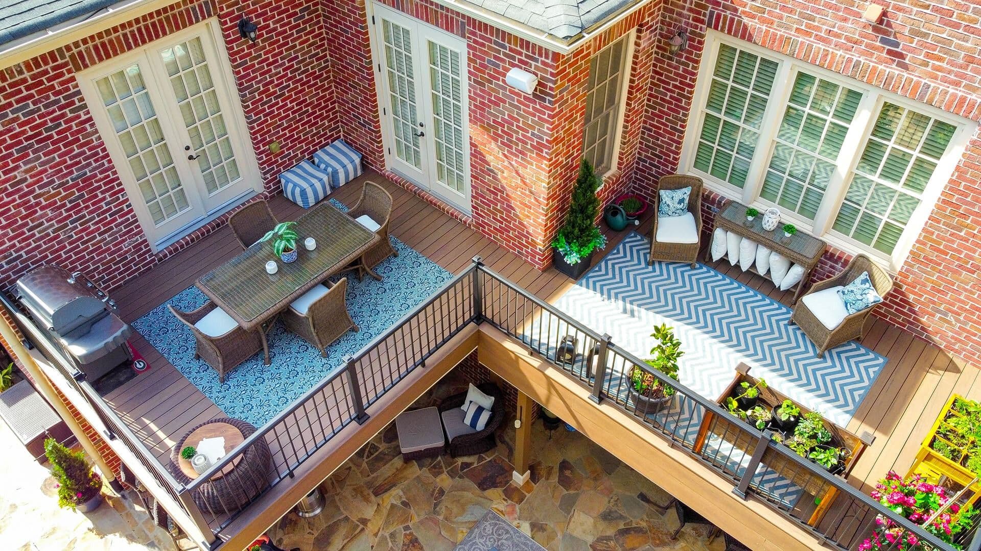 An overhead view of an outdoor deck by Outback Deck on a red brick house.