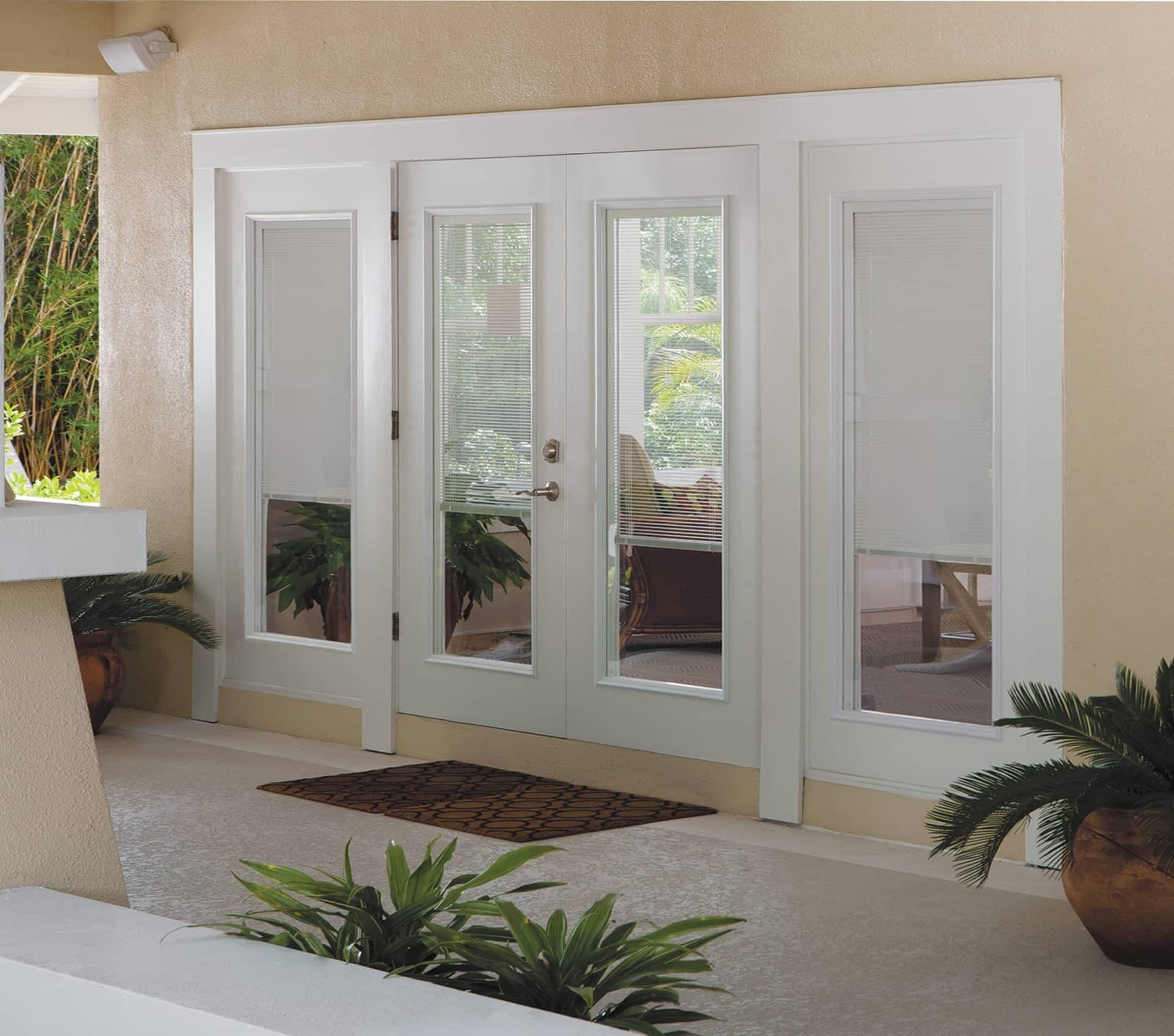 White patio doors with built-in blinds. on a tan house.