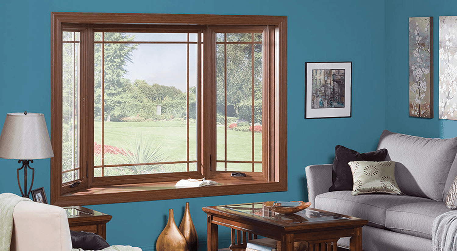 A bay window with brown wood frame in a blue living room.