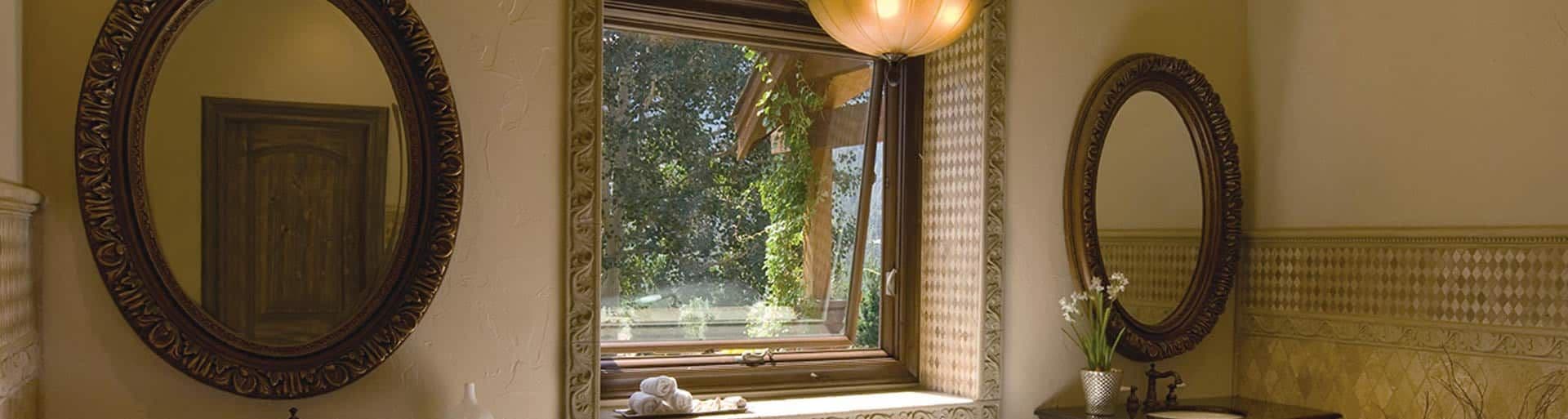 An open awning window in a bathroom above a double vanity.