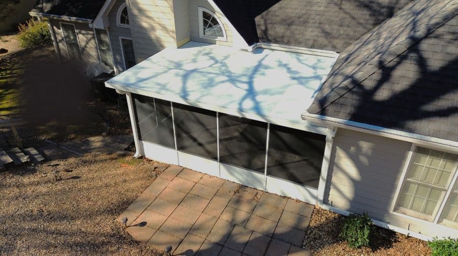 An overhead view of a white, covered, screened-in porch.