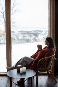 Woman drinking coffee at her window