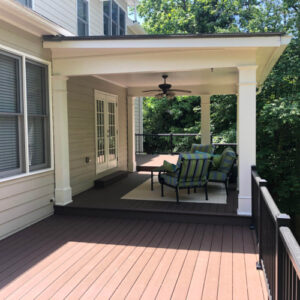 a composite deck patio with cover and furniture