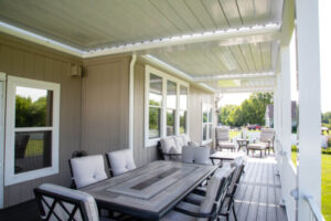a patio with composite deck floor and louvered pergola cover